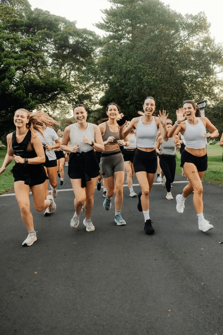 A group of women running together, laughing
